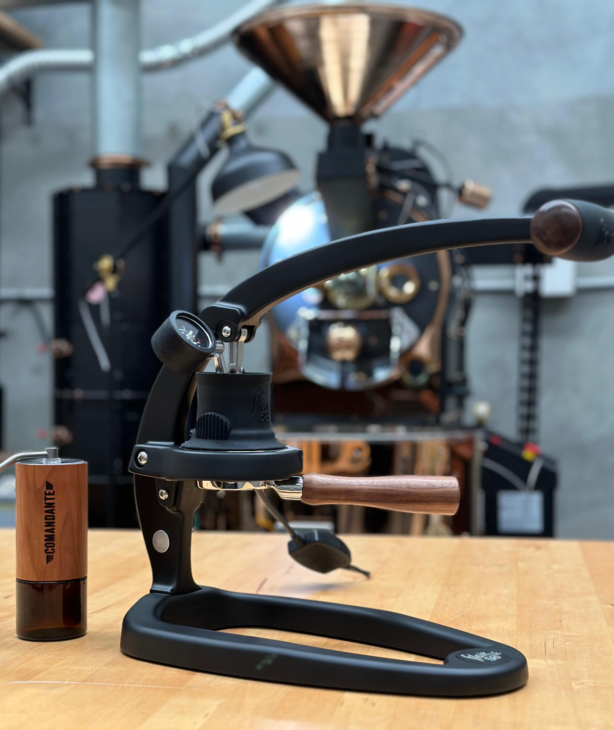 Flair 58LE Manual Lever Espresso Maker with Comandante C40 Grinder with Coffee Roaster in background